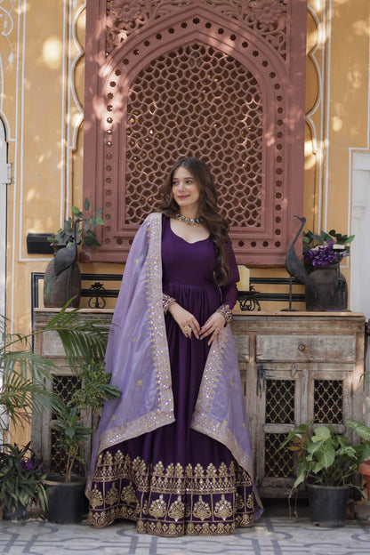 Full shot of a model in a purple gown with gold accents.