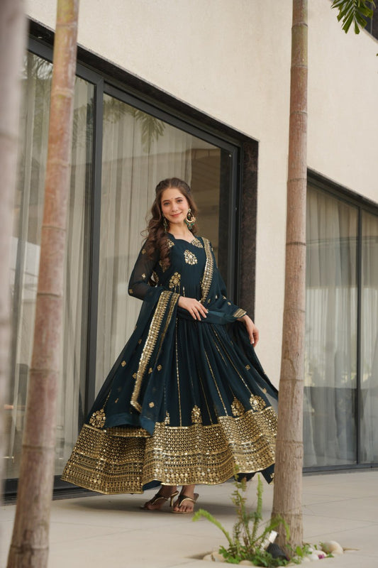 Full shot of woman in Rama green gown with dupatta, outdoor setting.