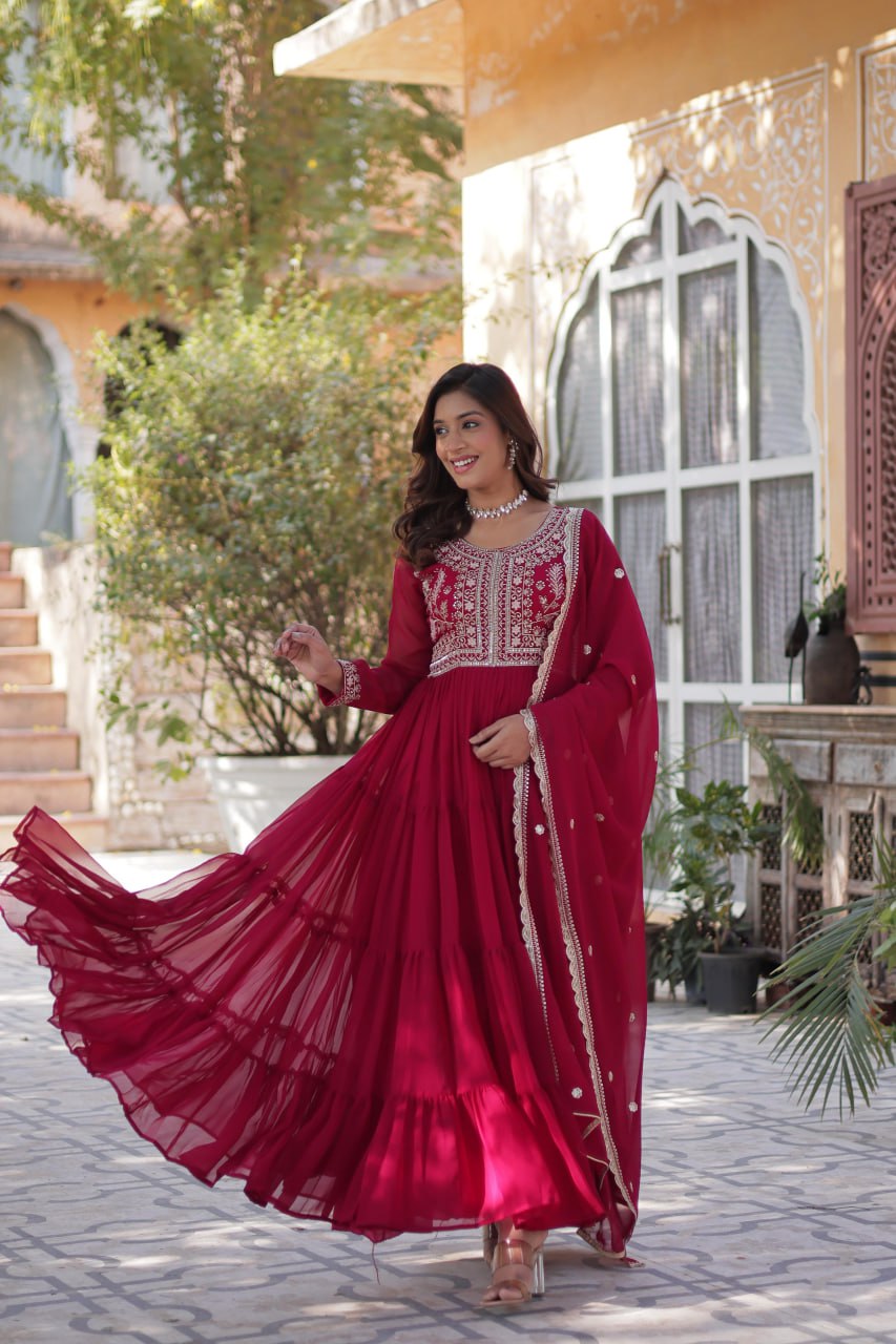 Woman in a red embroidered Georgette gown with dupatta.