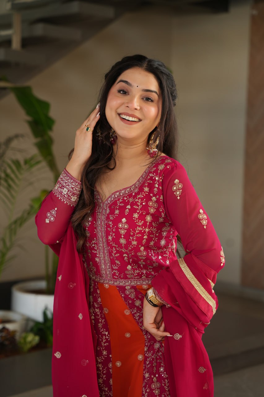 Overhead shot of a pink and orange zari embroidered gown with dupatta.