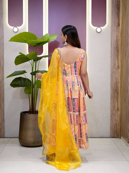 Back view of yellow Anarkali suit showing flared silhouette and dupatta detail.