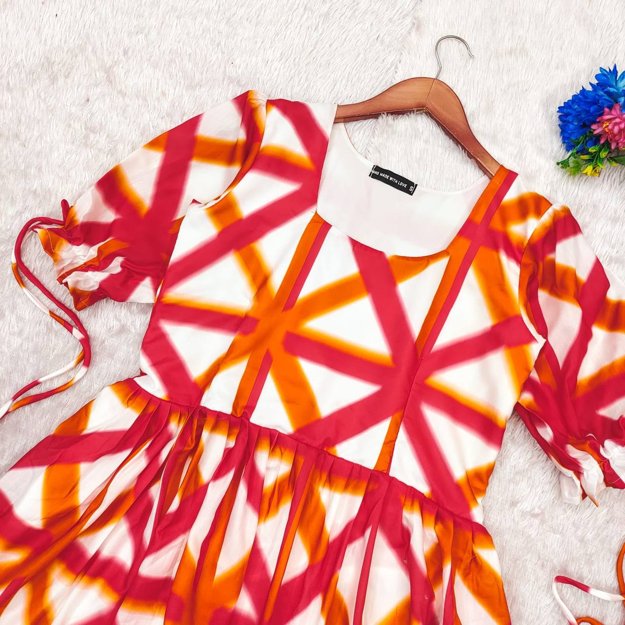 Close-up of the Sajda Maxi Dress in red-orange-white geometric print.
