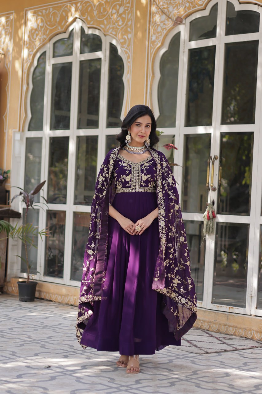 Two models, one in a pink and one in a purple embroidered Indian gown.
