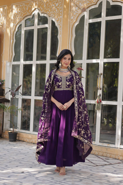 Two models, one in a pink and one in a purple embroidered Indian gown.