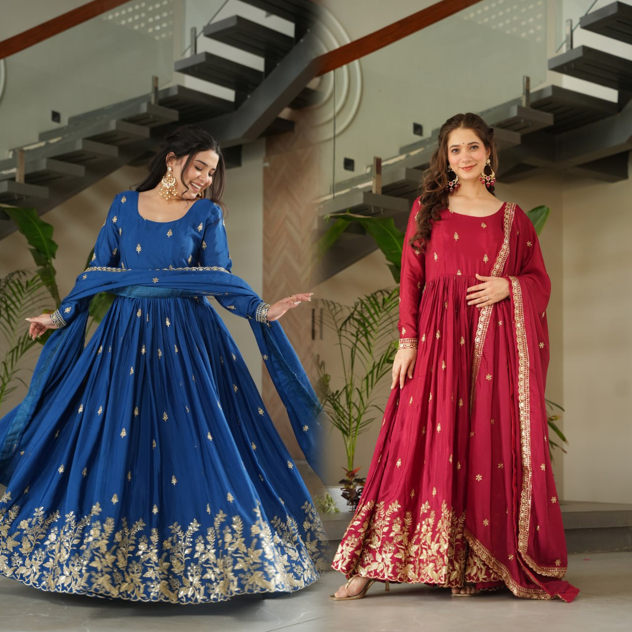 Two women in traditional blue and red dresses with floral patterns indoors.