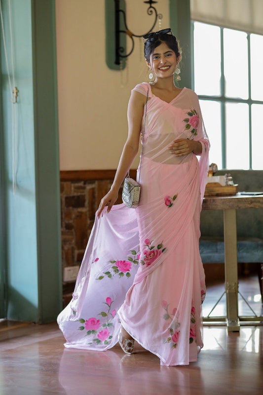 Woman wearing a pink georgette rose saree and silver purse.
