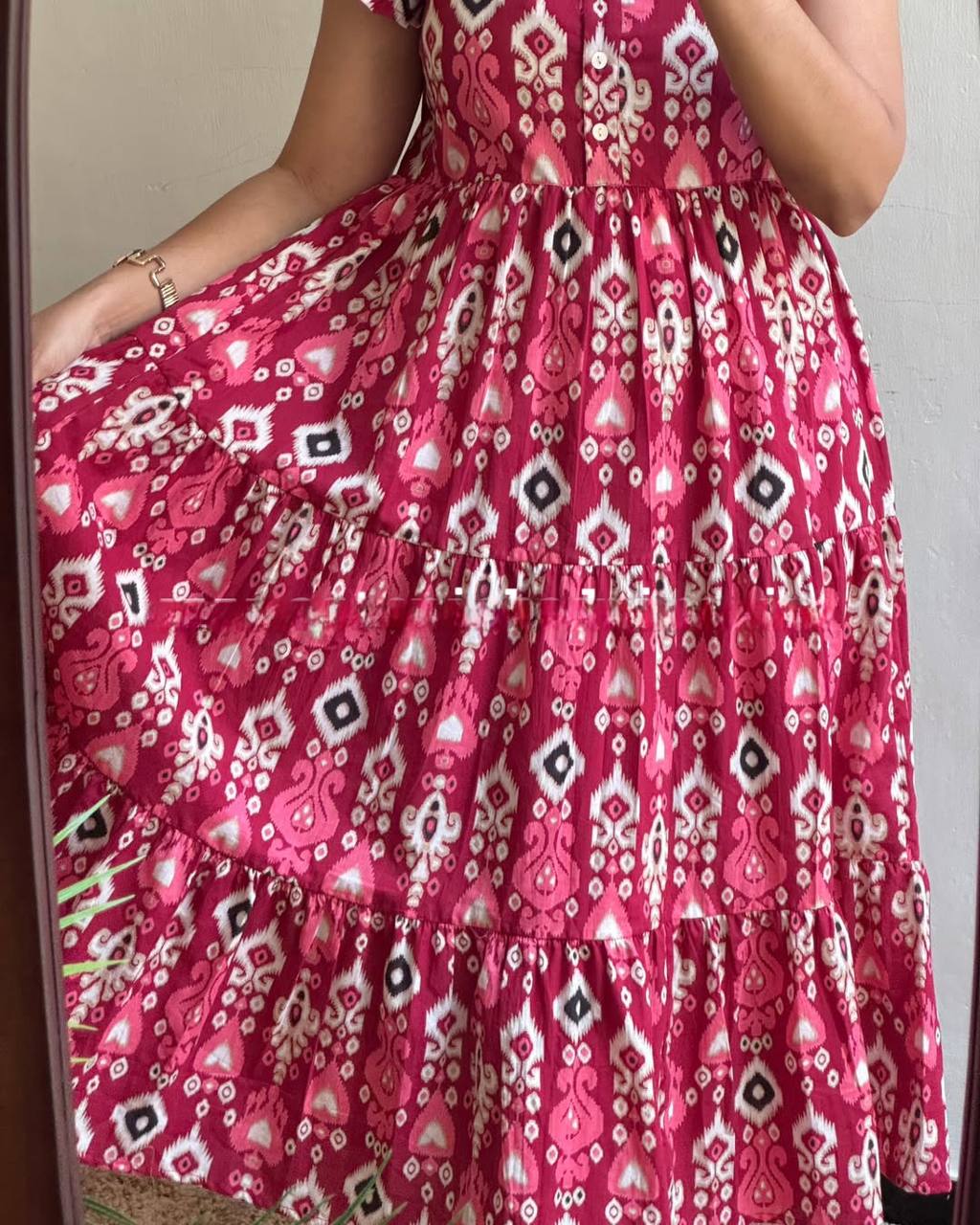 Close-up of the Dhano Maxi pink Patola dress showing the tiered design.