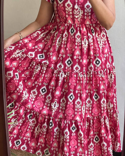 Close-up of the Dhano Maxi pink Patola dress showing the tiered design.