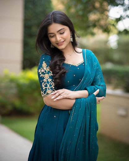 Model wearing a teal Morpankh Anarkali with gold embroidery.