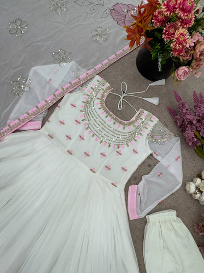 Close-up flatlay of gown bodice, showing sequin embroidery and pastel pink floral dupatta.