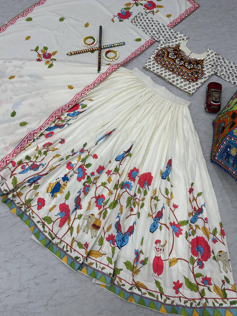 Gamthi Grace Lehenga Choli laid out, highlighting intricate peacock, elephant, and floral skirt prints.