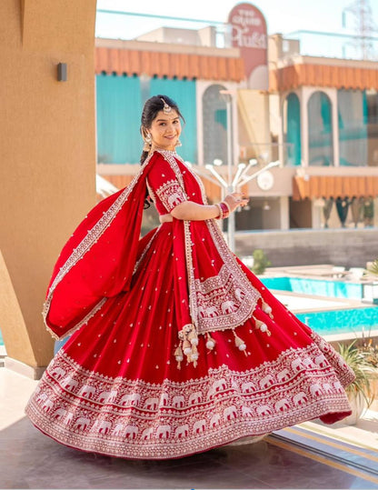 Red embroidered lehenga choli set with elephant design.