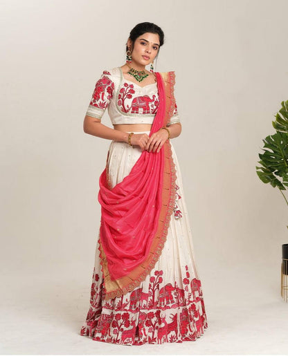 Full view of Kalamkari lehenga choli set in white and red.