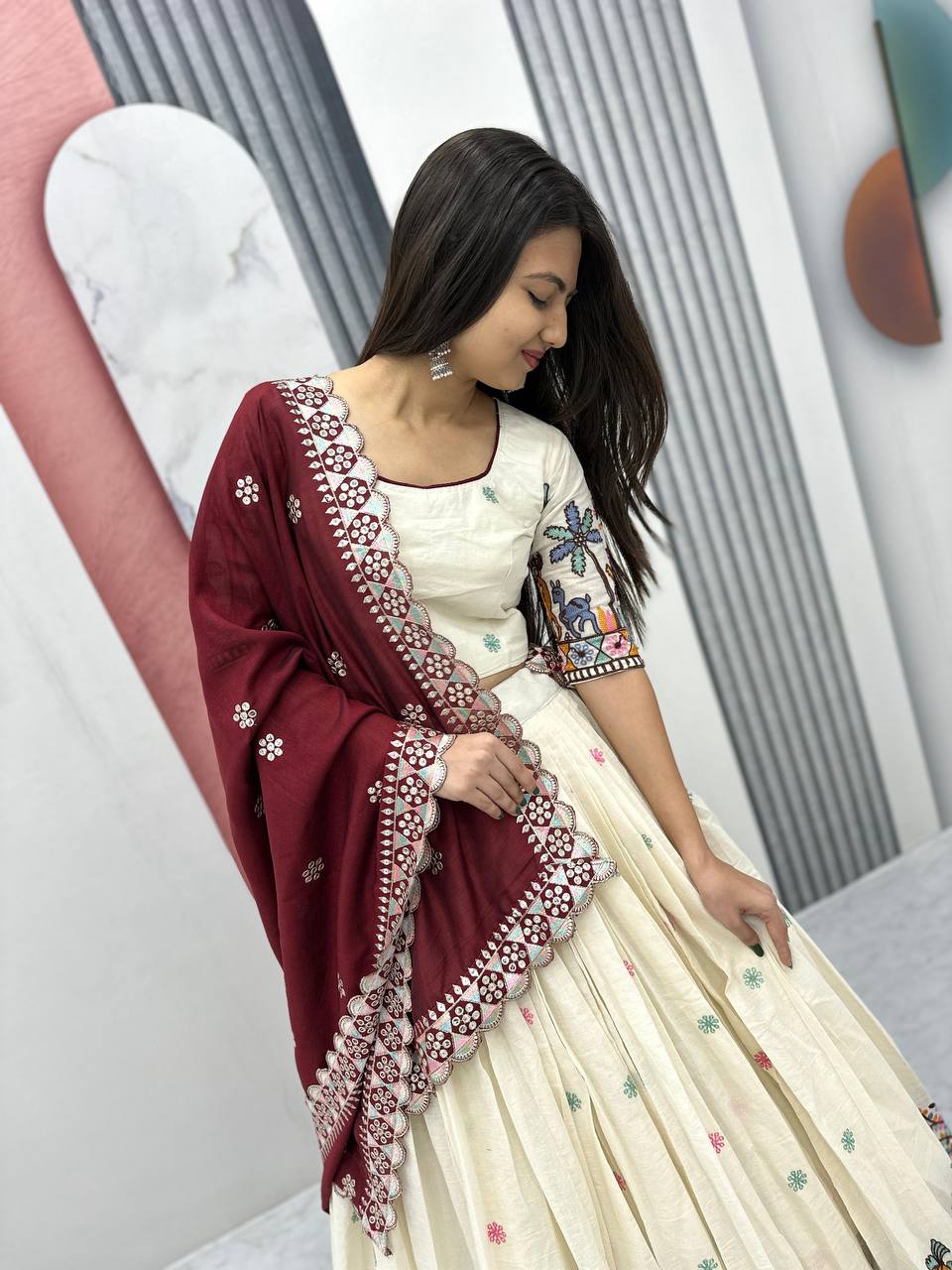 Woman in Rangbhoomi Lehenga, showcasing the maroon dupatta with delicate sequence work.