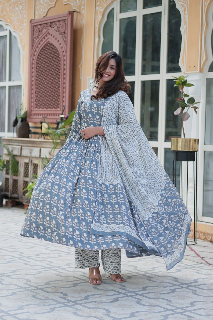 Woman twirling in a blue pure cotton kurti set with printed dupatta, highlighting the flared skirt design.