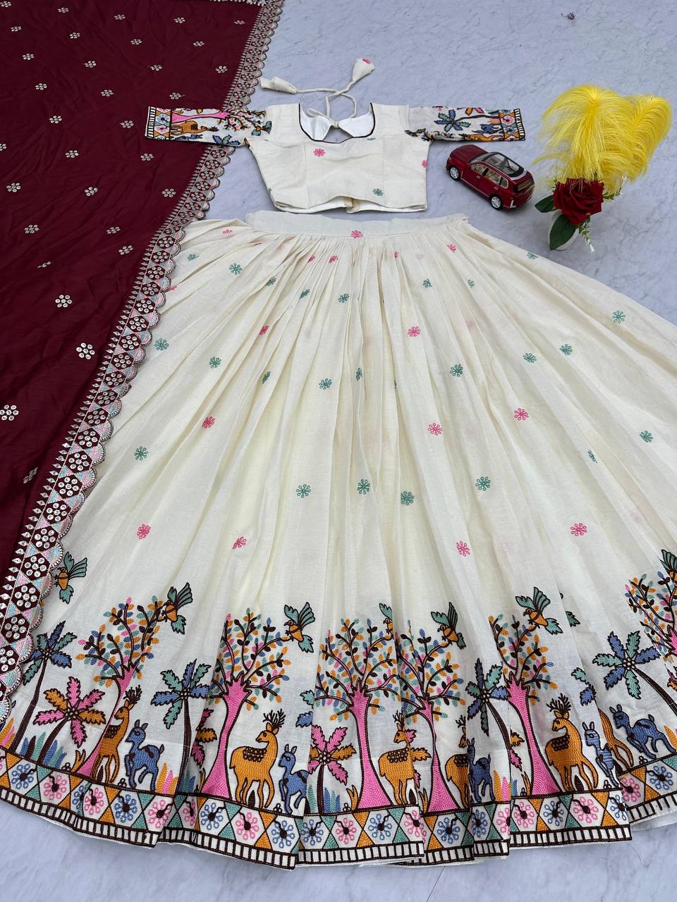 Close-up of Rangbhoomi Lehenga's border, featuring tree and animal design.