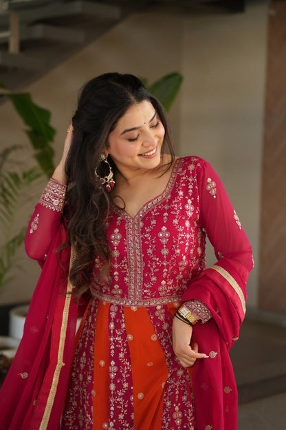 Close-up of a woman in a pink and orange zari embroidered gown.