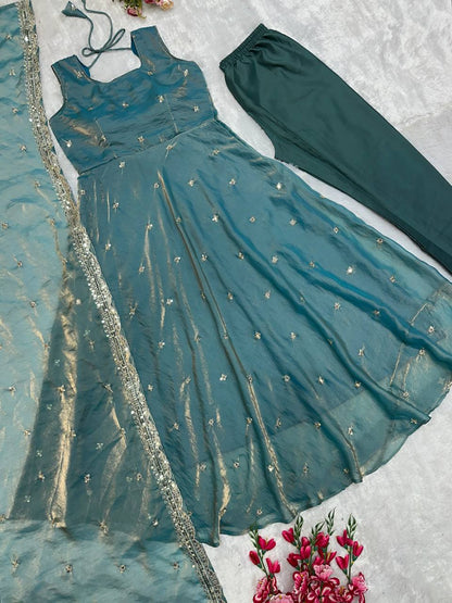 Elegant designer gown ensemble in teal with embroidery.