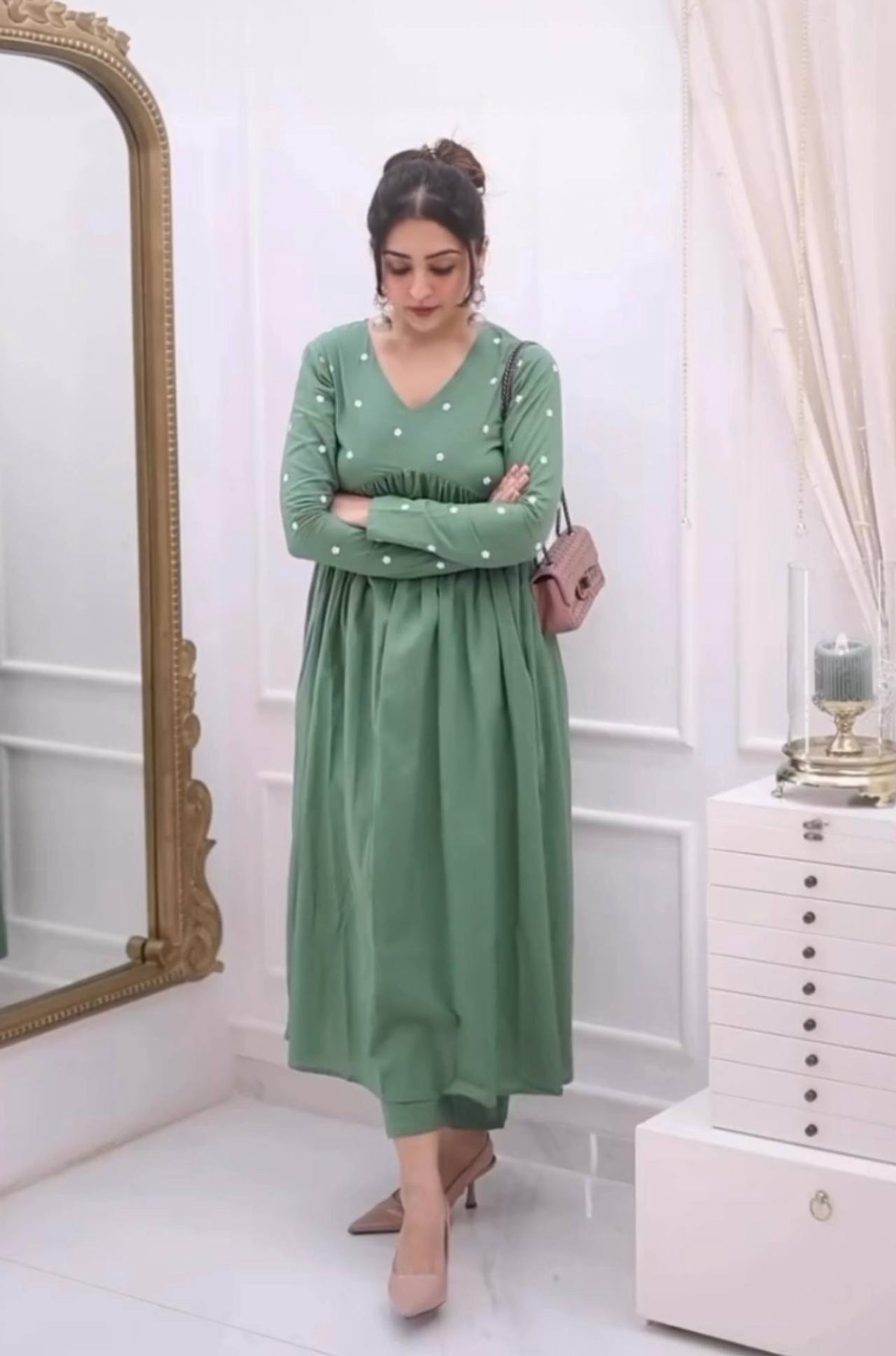 Woman modeling the light green Farheen silk co-ord set with purse.