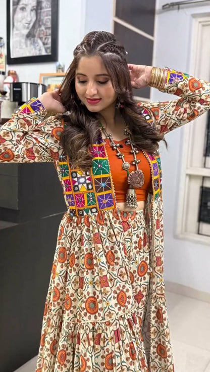 Woman adjusting hair in Kachchi Charm lehenga choli, featuring bold prints and mirror embroidered shrug.