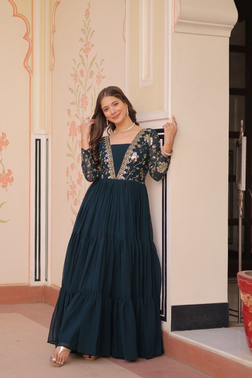 Woman posing in green embroidered premium gown