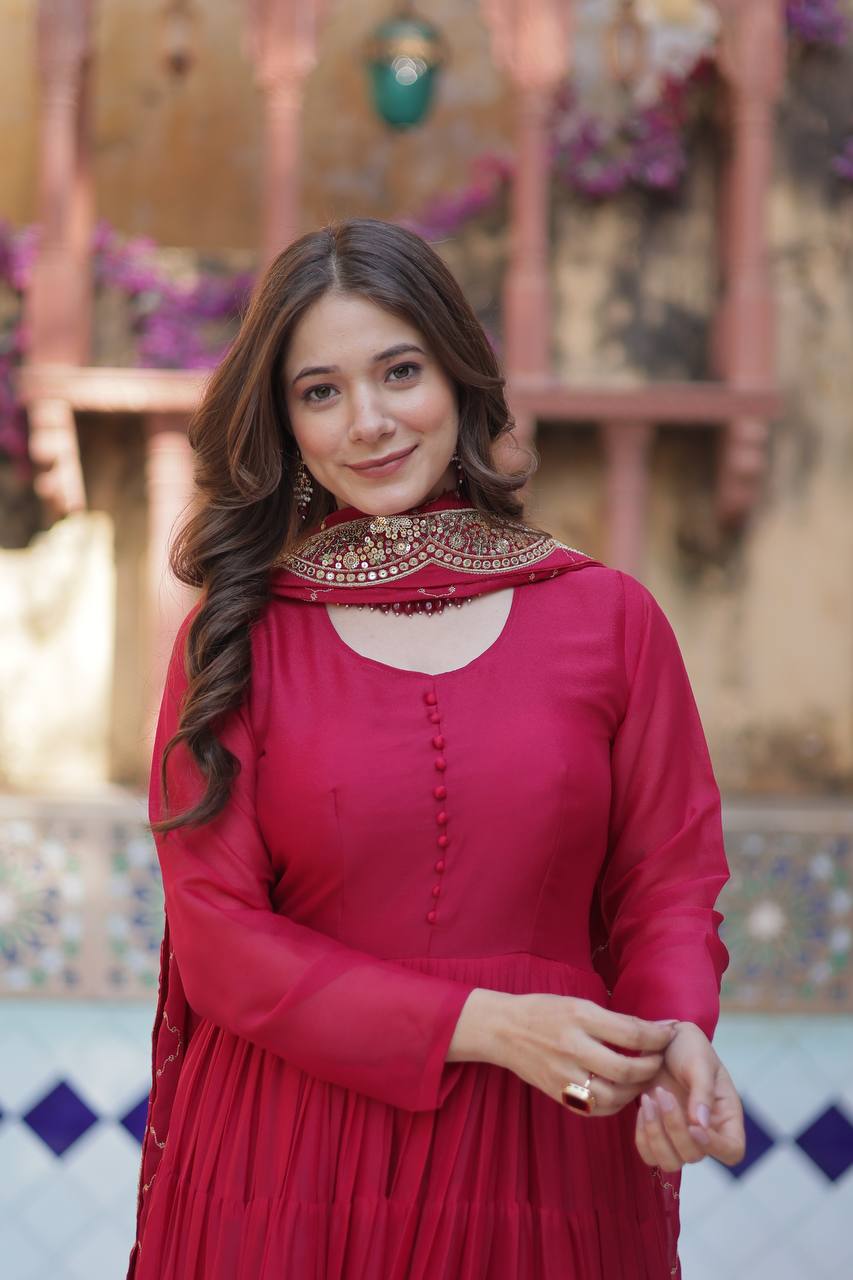 Close-up of a woman wearing a red flared gown with an embroidered dupatta.