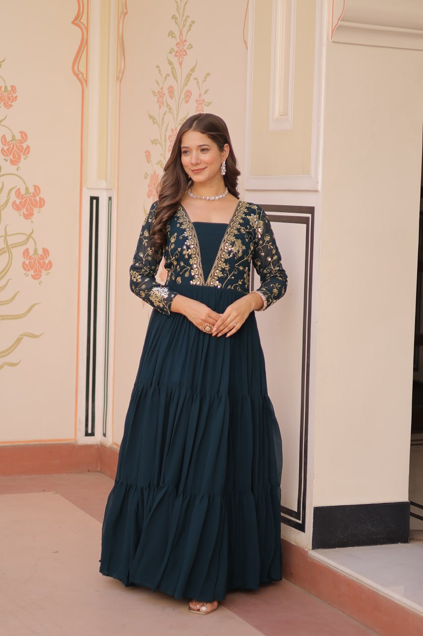 Model in green gown with V-neck and gold details
