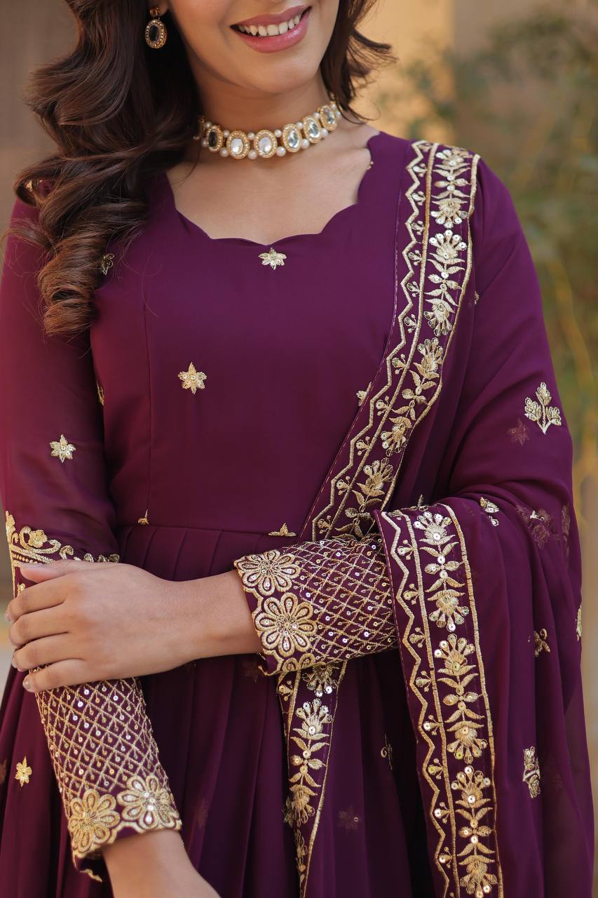 Detailed view of a plum Anarkali gown's sleeve and neckline embroidery.