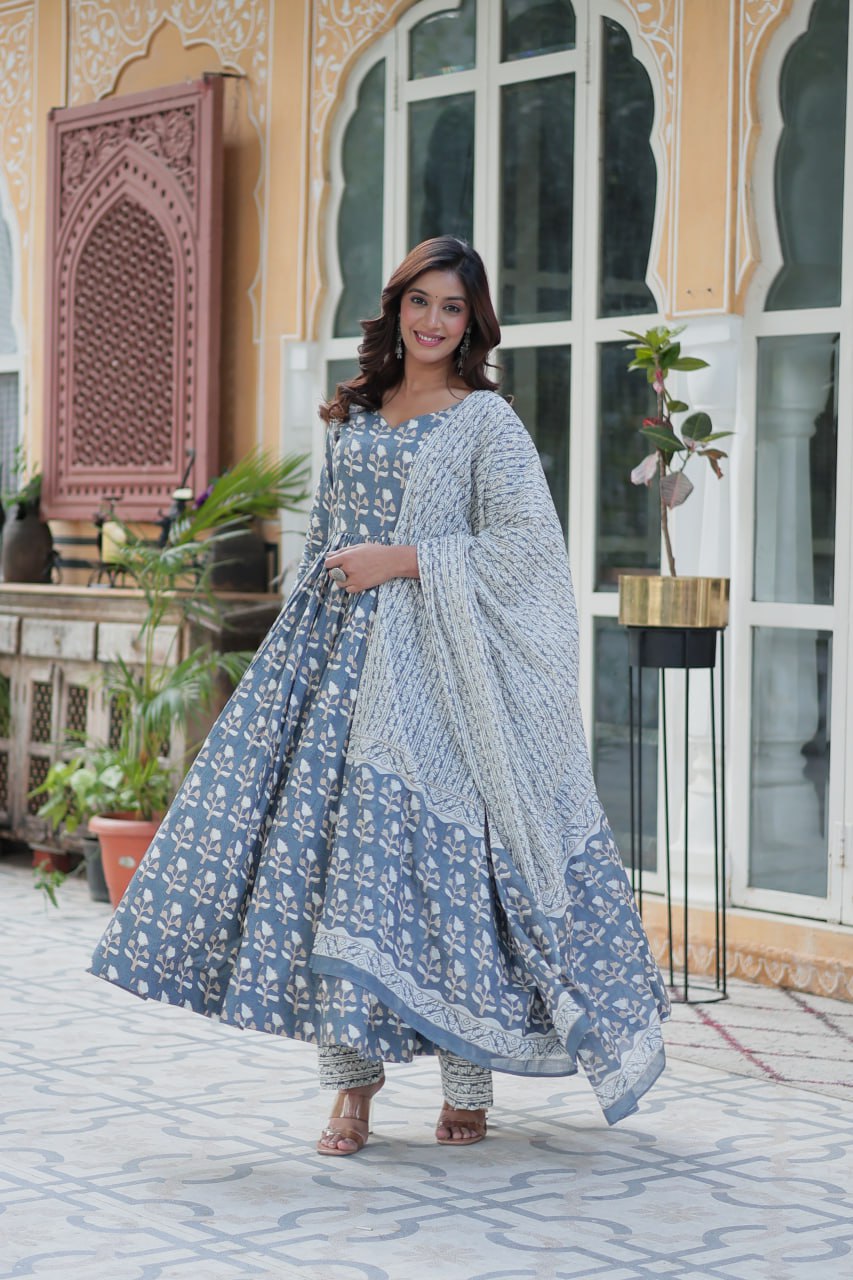 Back view of orange cotton kurti set, highlighting the flowy dupatta and detailed traditional print.