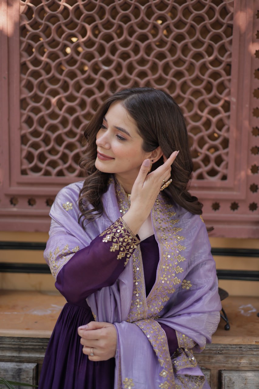 Detailed embroidery on the purple designer gown dupatta.