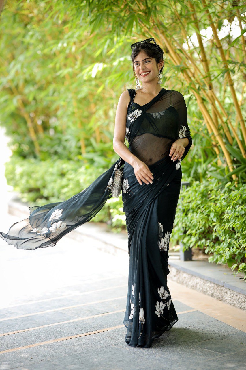 Close-up of intricate floral embroidery on a black georgette ready to wear saree.