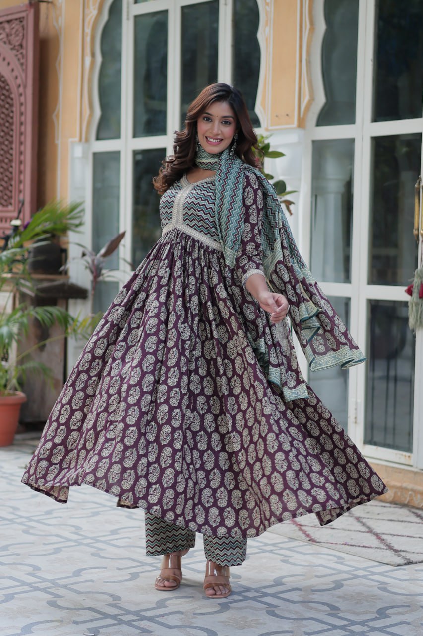 Elegant mustard block print kurti set with teal chevron dupatta, V-neck lacework, full sleeves, model smiling.