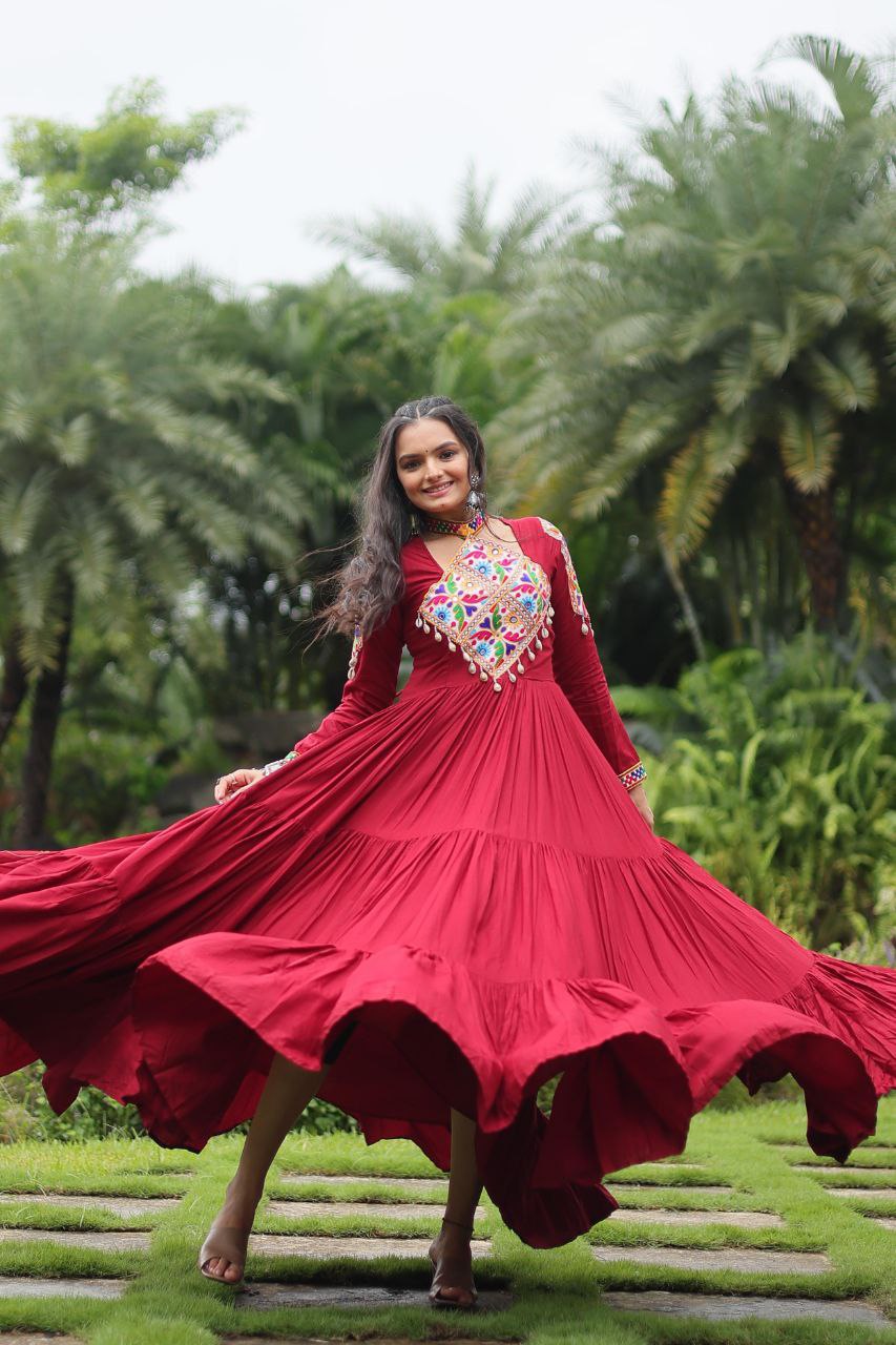 Maroon Kutchi embroidered Gamthi Gown in motion, displaying its dramatic three-layered flair and festive charm.
