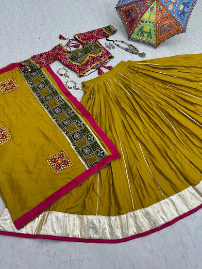 Flat lay of golden lehenga choli, ornate dupatta, jewelry, and festive Navratri umbrella.