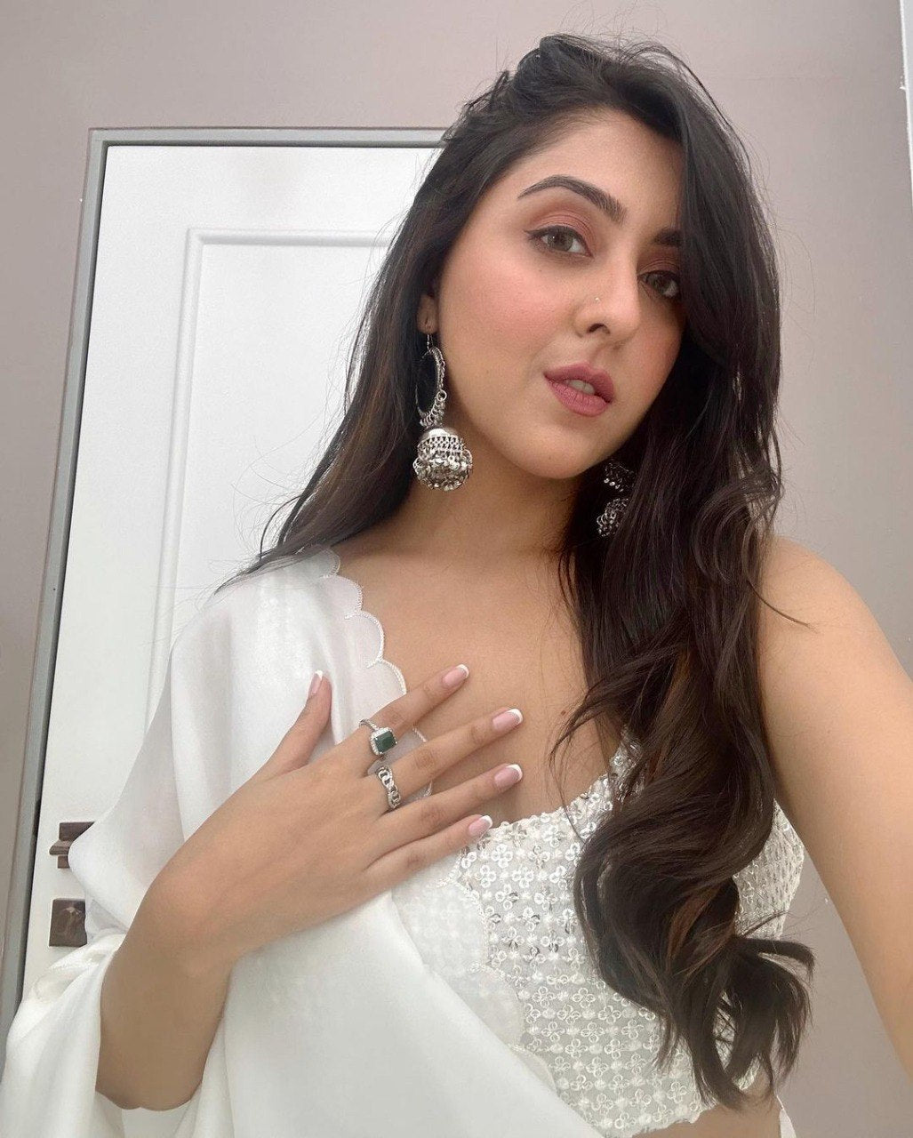Complete ensemble: Pristine white saree paired with beaded and sequined blouse.