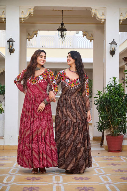 Women in red and brown Gamathi gowns, walking arm in arm, ready for festive Navratri events.