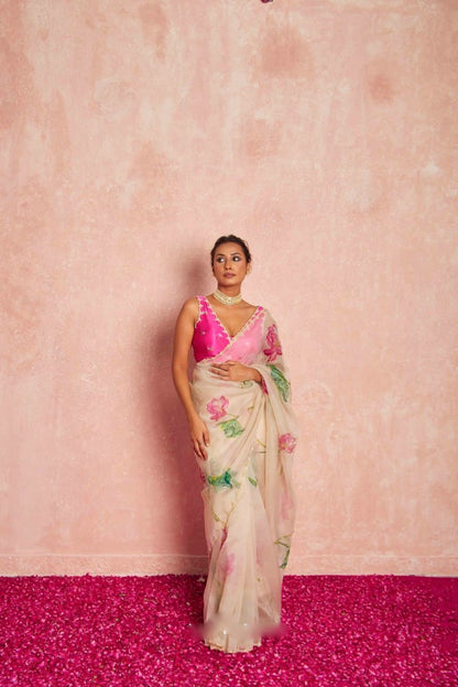 Model wearing elegant pink organza silk saree with floral design.