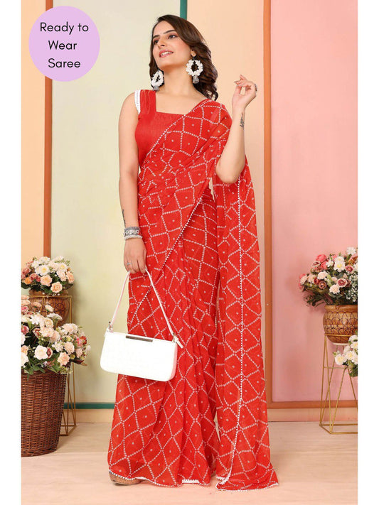 Elegant orange georgette ready to wear saree with geometric pattern and delicate white lace border.