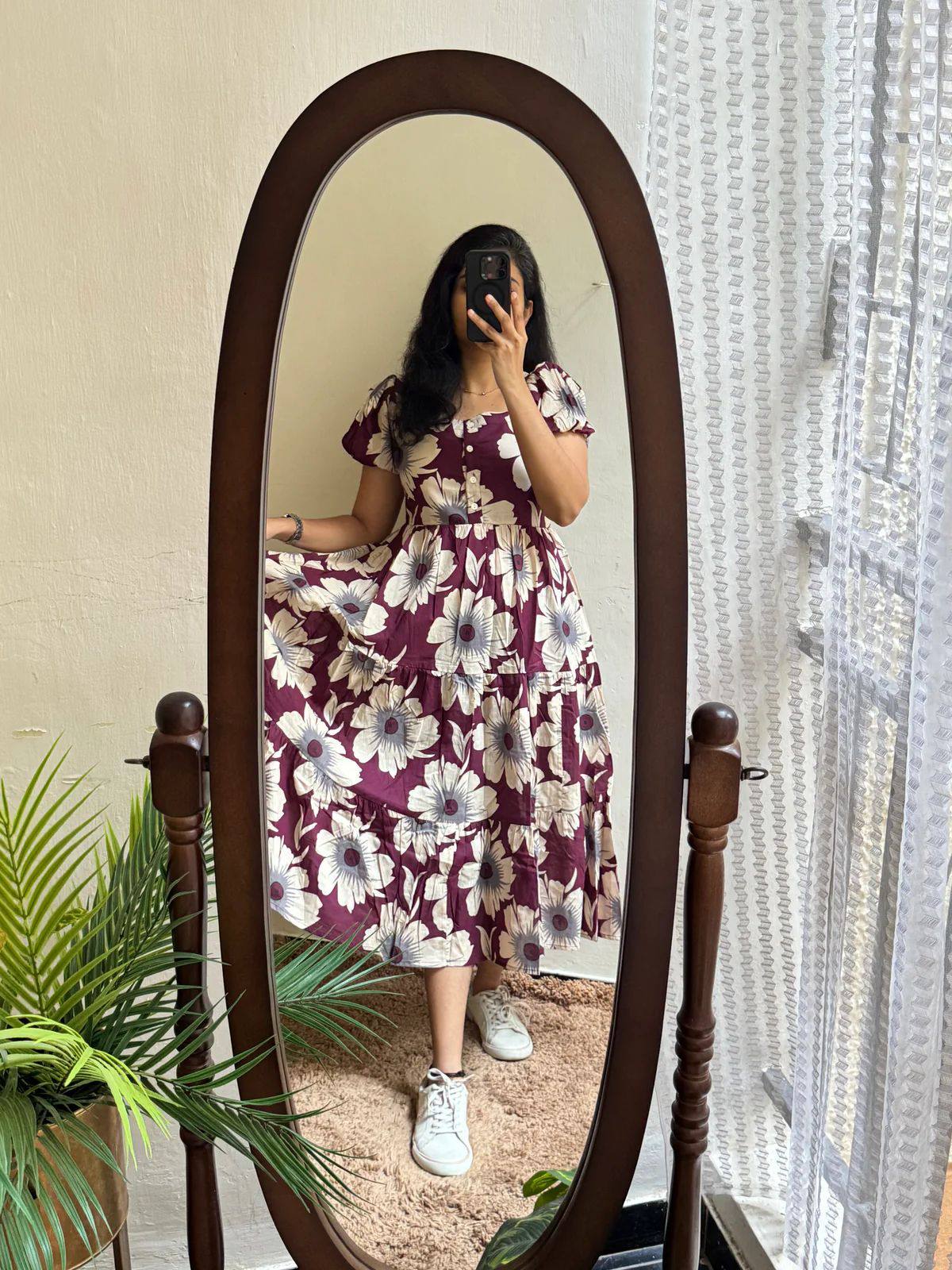 Woman wearing maroon floral maxi dress with sneakers, a comfortable outfit.
