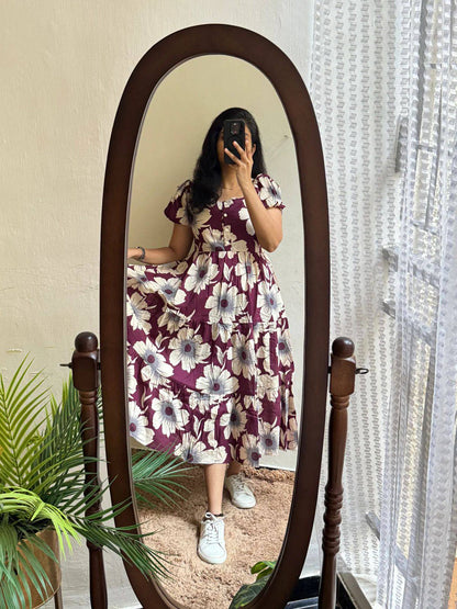 Woman wearing maroon floral maxi dress with sneakers, a comfortable outfit.