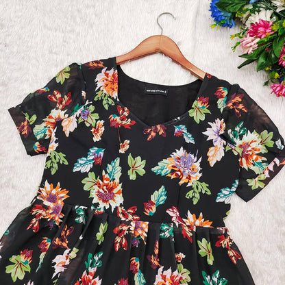 Close-up of the Floral Getaway black floral dress. Details of the neckline and floral pattern visible.