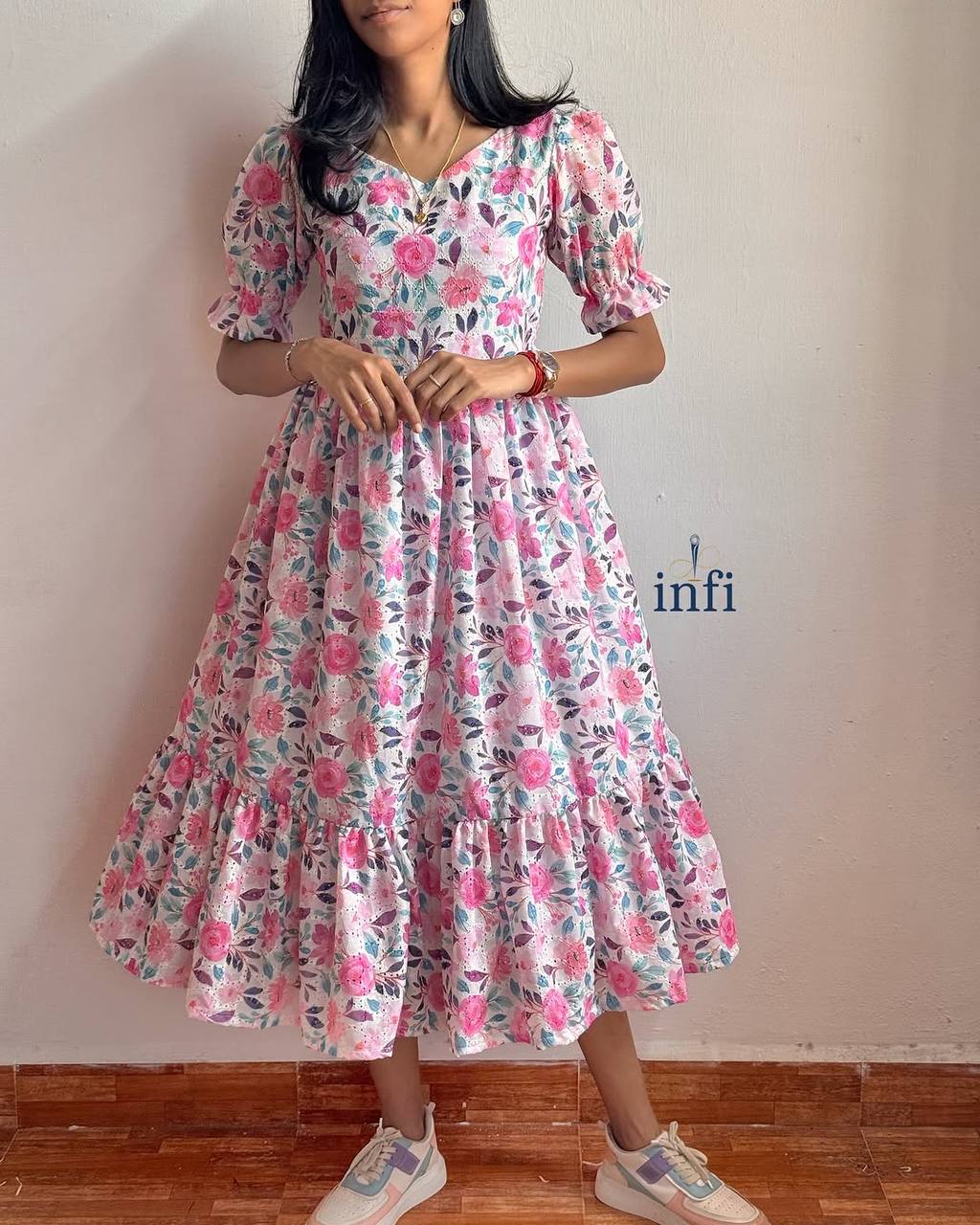 Elegant Lily Dress: A floral maxi dress with a tiered skirt and short sleeves.