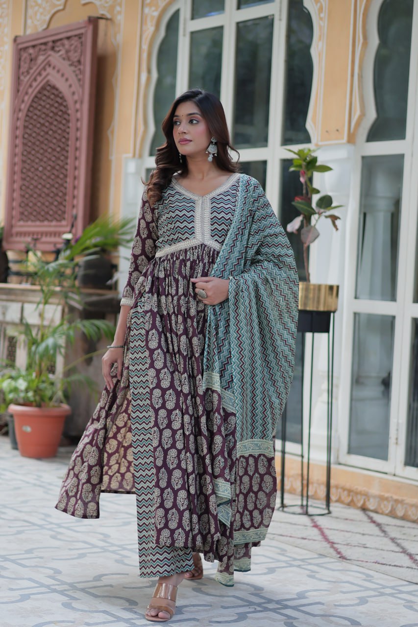 Maroon and gold cotton Anarkali kurti set with teal chevron dupatta, V-neck, and flowing fit, worn outdoors.