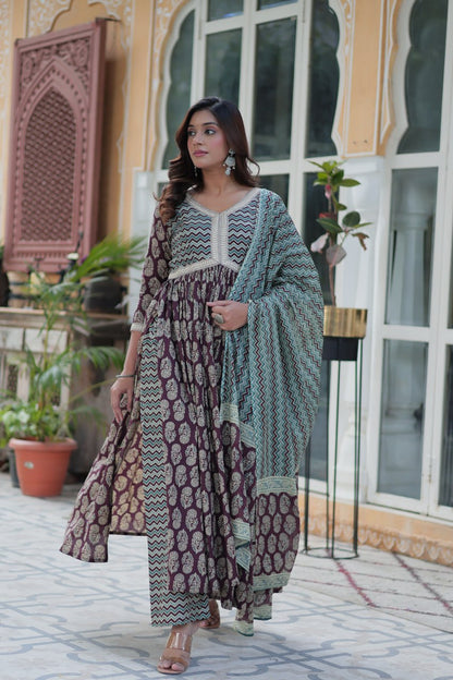 Maroon and gold cotton Anarkali kurti set with teal chevron dupatta, V-neck, and flowing fit, worn outdoors.