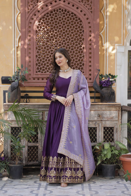 Close up of a woman in a purple gown with gold embroidery.