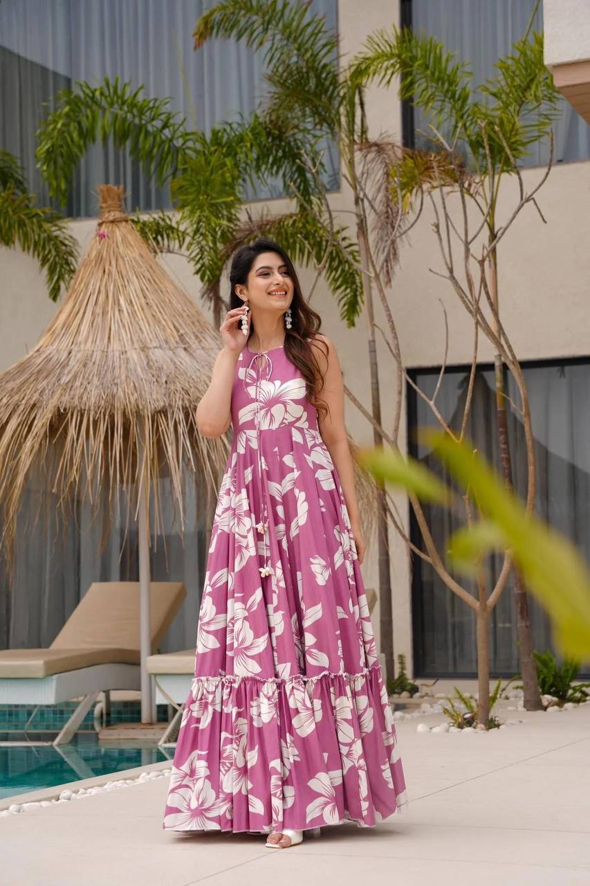 Woman in pink floral dress, South Indian style, sleeveless design.