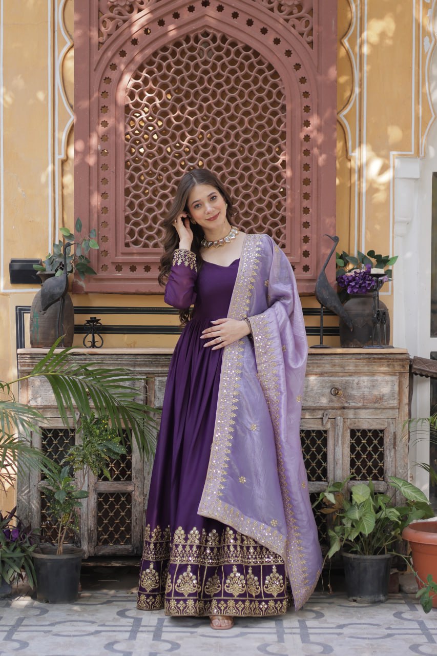 Detailed view of embroidered sleeve and purple dupatta.