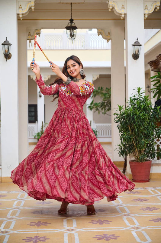 Navratri Bandhni print red gown in motion, featuring mirror work and colorful lace, ideal for festive dancing.