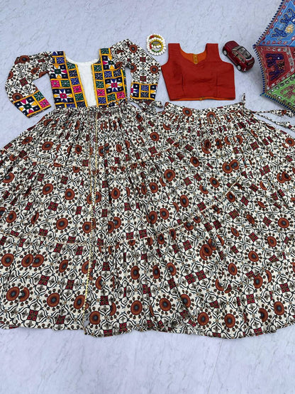 Flat lay of full Kachchi Charm lehenga choli set with embroidered shrug, orange blouse, and flared skirt.
