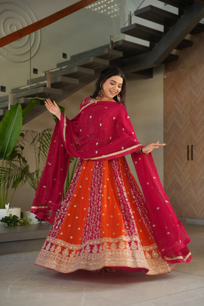 Close-up of designer embroidery on a pink and orange gown.
